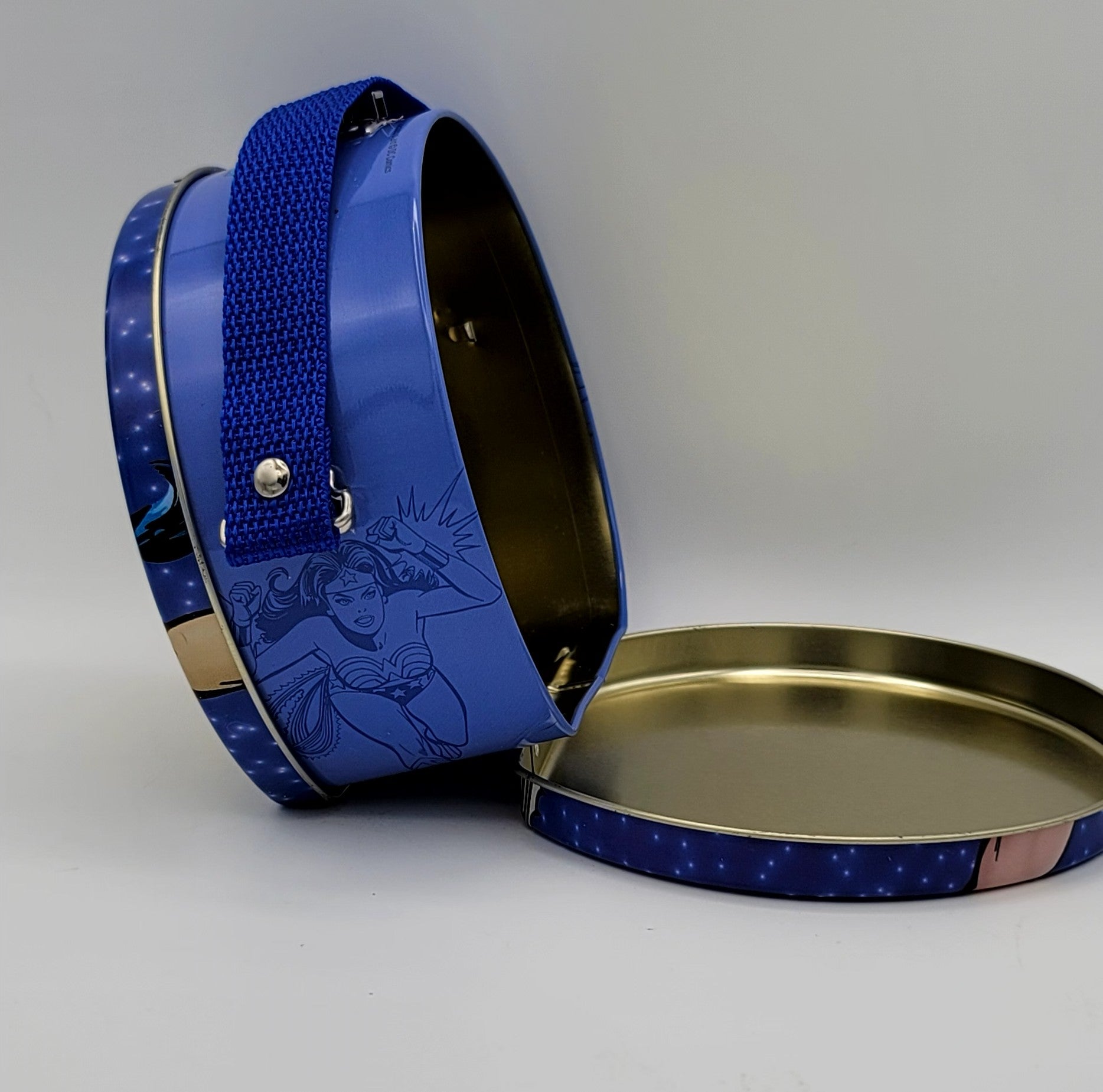 Wonder Woman round tin purse carry case with blue strap and comic-style DC superhero artwork