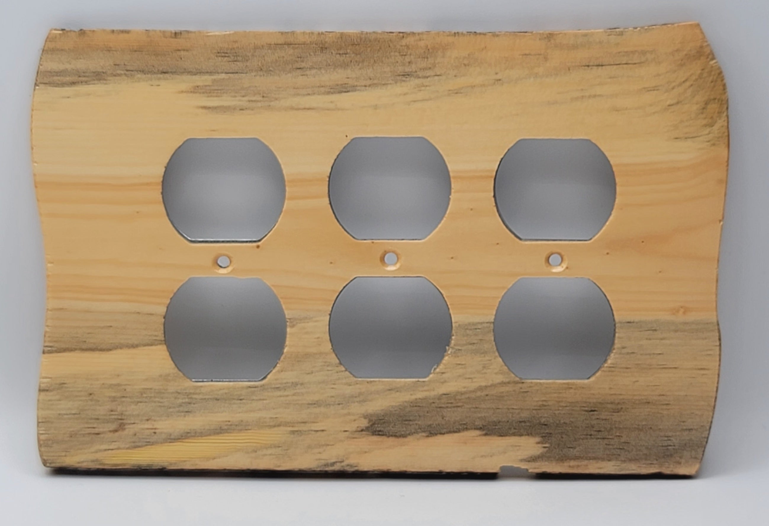 A rustic, handcrafted wooden wall plate or decorative panel with six circular cutouts, showcasing natural wood grain patterns in light and dark brown tones.