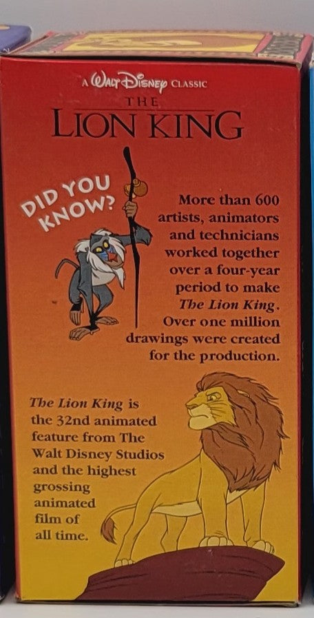 A vintage Walt Disney Classic 'The Lion King' collectible box, showing the front cover with text and illustrations of Simba and Mufasa on a red and yellow background.