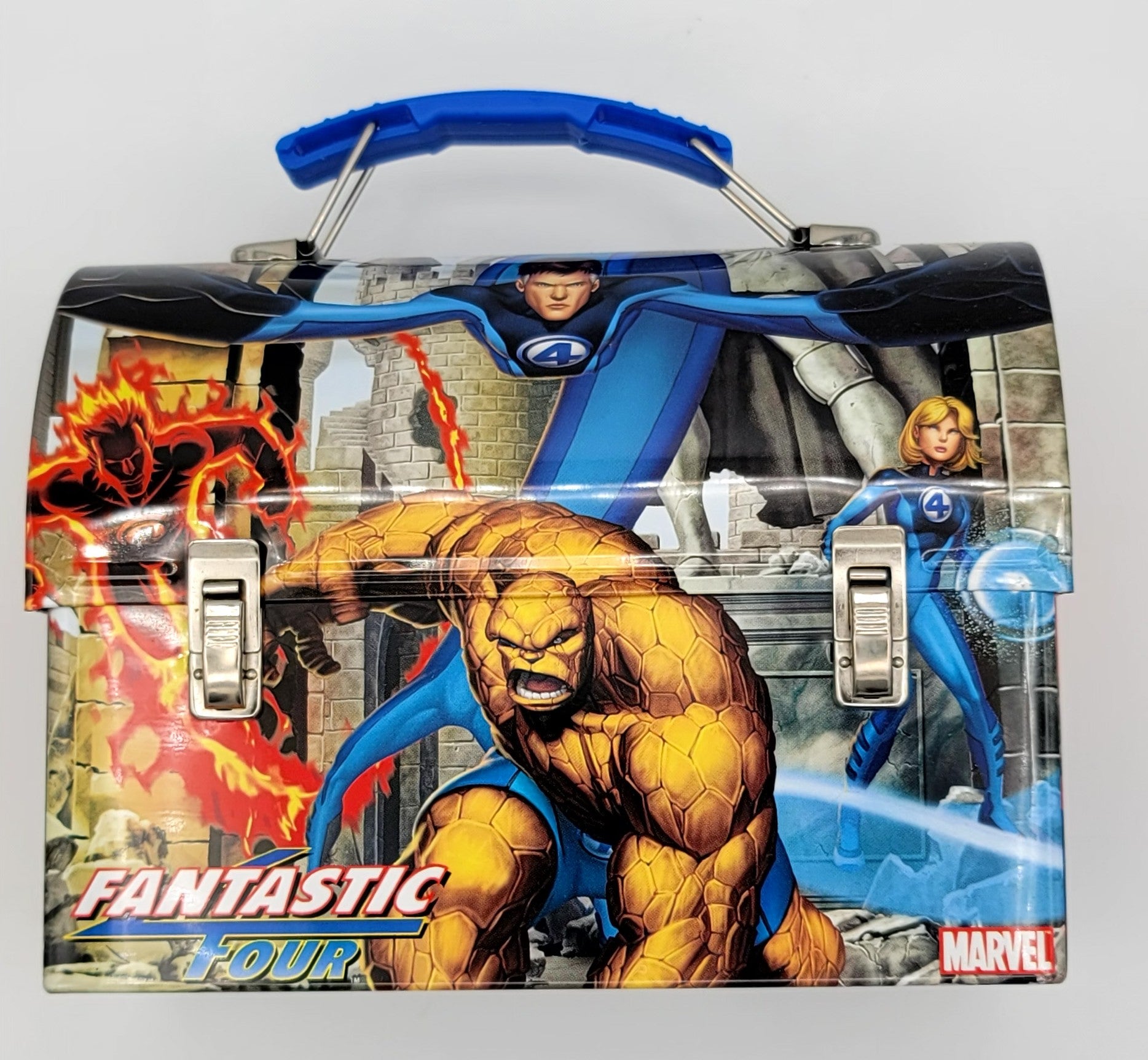 A Marvel Fantastic Four plastic lunch box featuring characters including the Thing, Human Torch, and Invisible Woman, with a blue handle and silver latches, set against a plain light gray background.