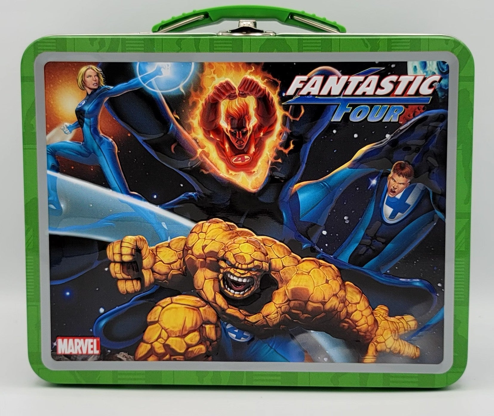 A green metal lunch box featuring a colorful 'Fantastic Four' comic book cover illustration with Marvel branding.