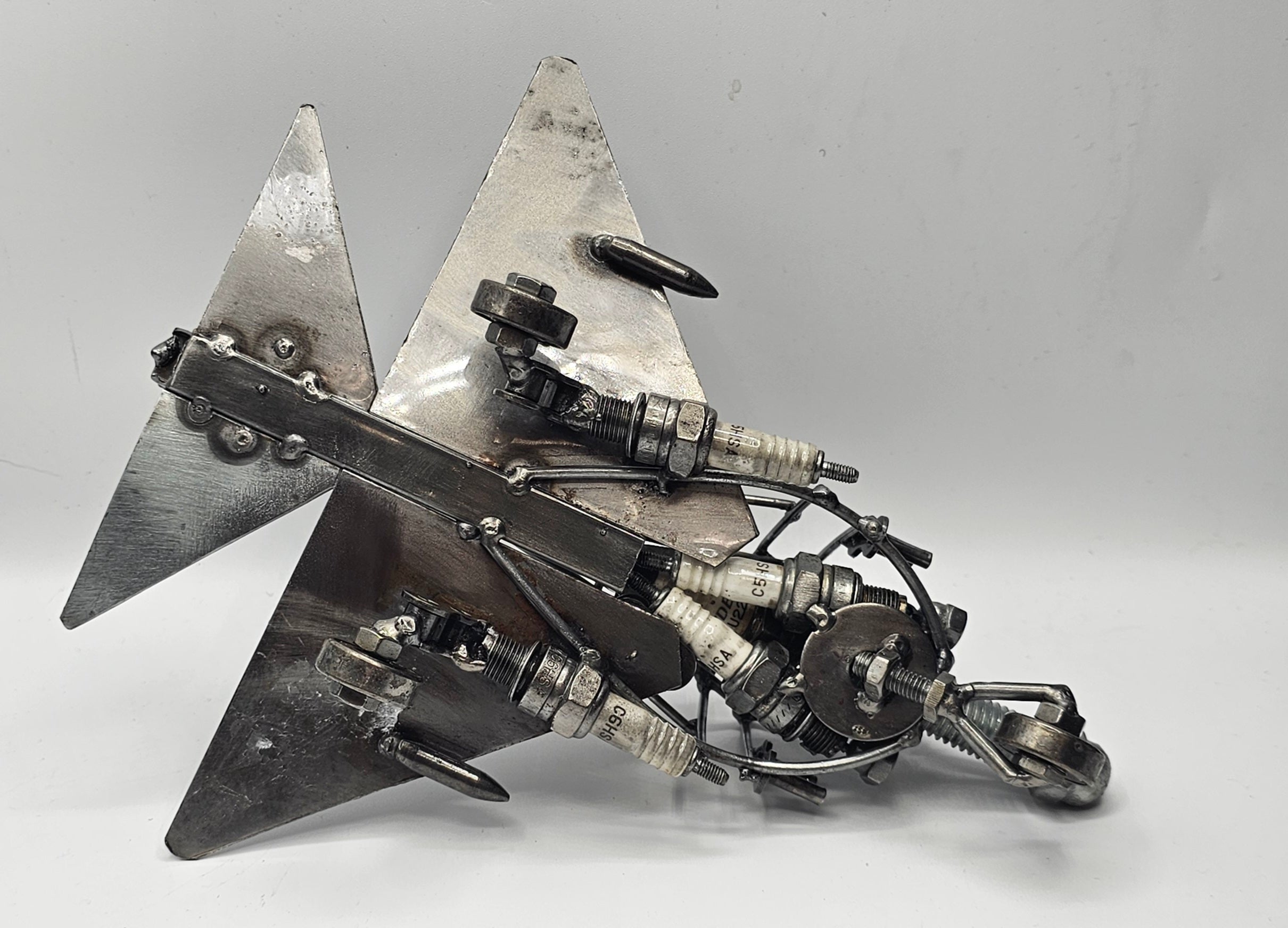 MIG-21 Fishbed fighter jet metal art made from a spark plug, military aviation collectible detail view