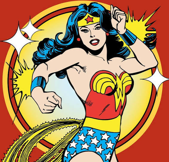 Comic-style Wonder Woman illustration on a red background, with a yellow circular burst and white starburst shapes. The character wears a red top, blue skirt with white stars, blue hair, and a yellow tiara.